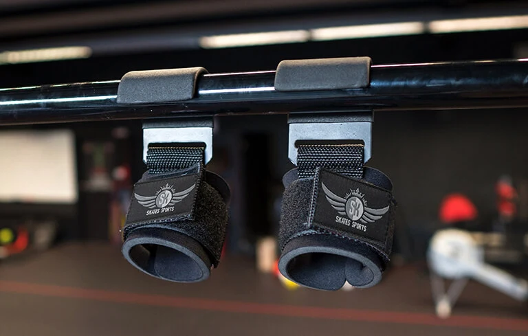 Skates sports hook straps hanging on bar